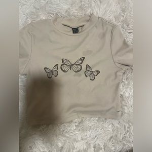 light brown shirt with darker brown butterflies. size :XS